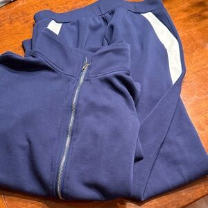 Navy Blue Tracksuit with White Accents. Full zipper jacket. Pants with pockets.